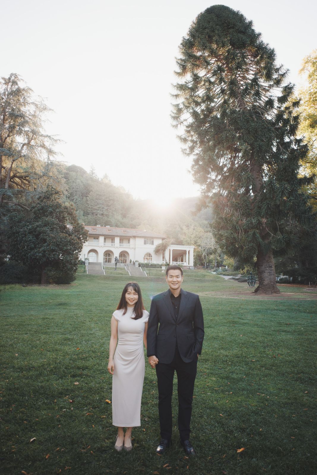 Couple sharing a tender moment under the archways of Montalvo Arts Center by SlowMo Studio