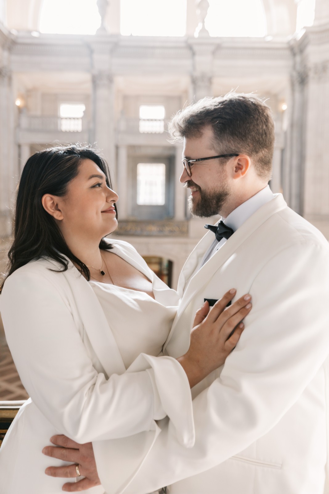 Newlyweds walking through San Francisco City Hall with natural light by SlowMo Studio